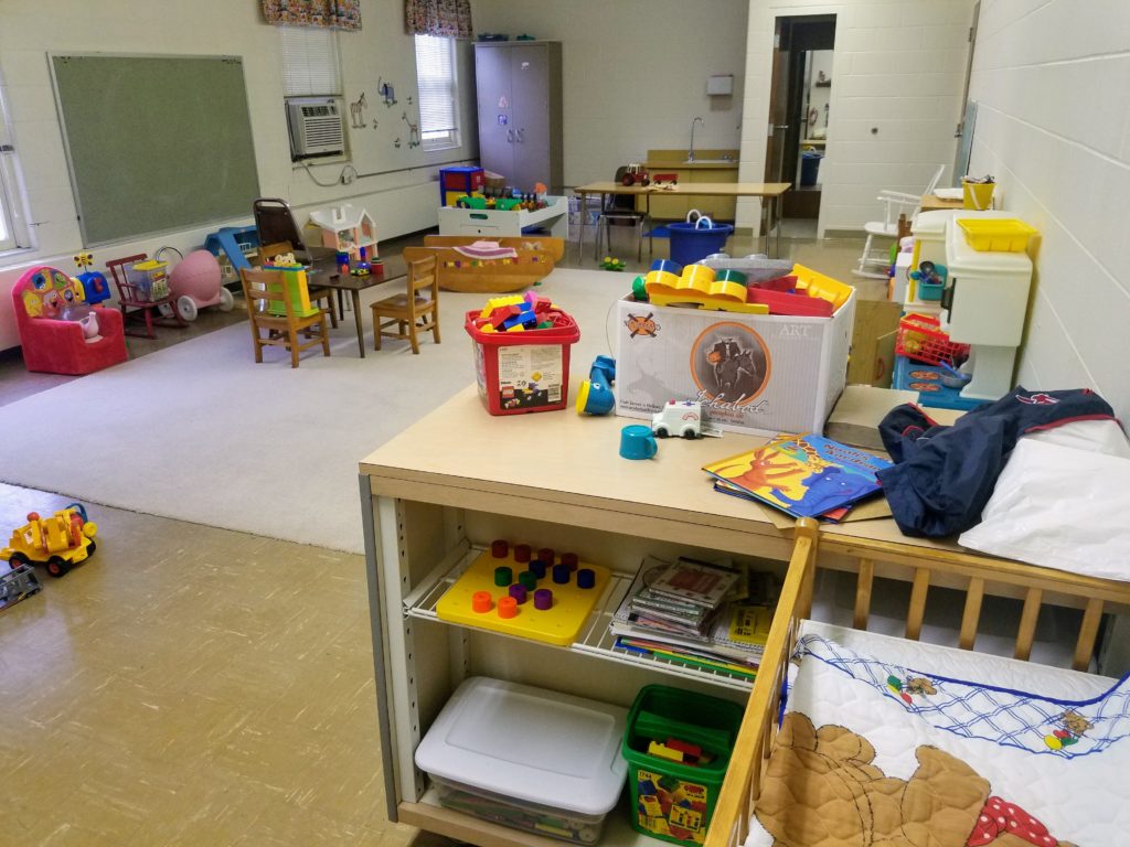 The church nursery, with toys and small table and chairs and windows.
